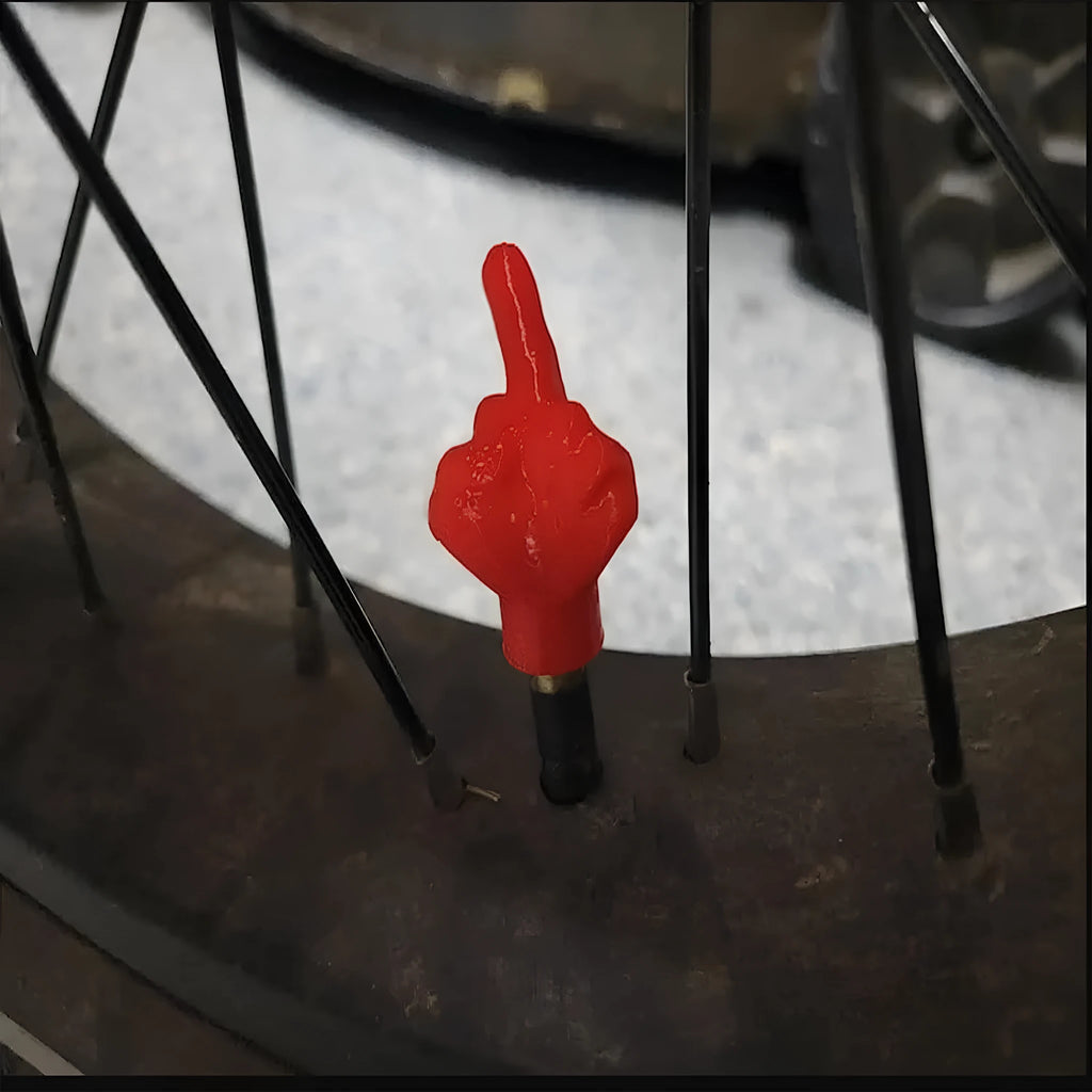 Eight latex car tyre valve caps, four black and four skin colour, for dust protection.
