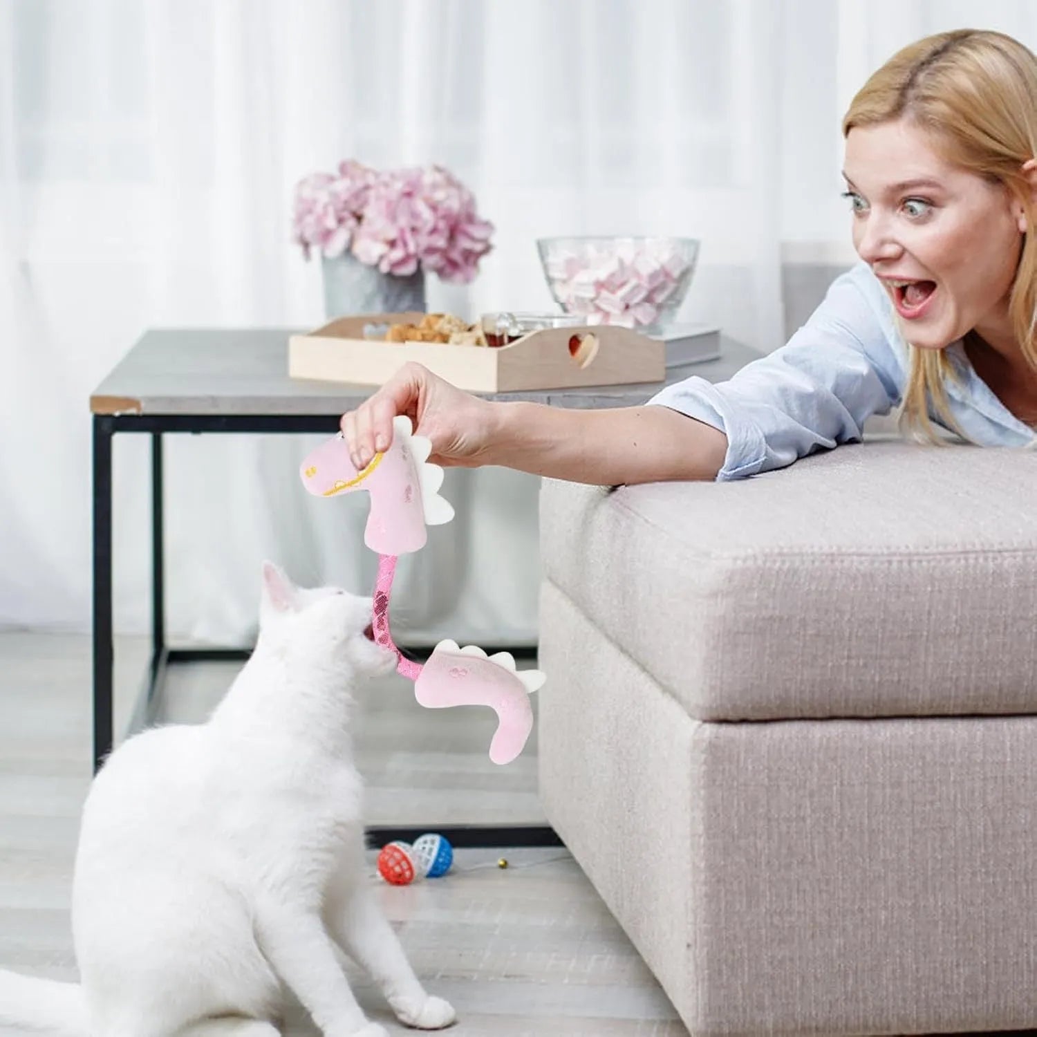 Set of four cat toys including rope, kicker toy, springs, and plush chew toys in pink, purple, or yellow colours