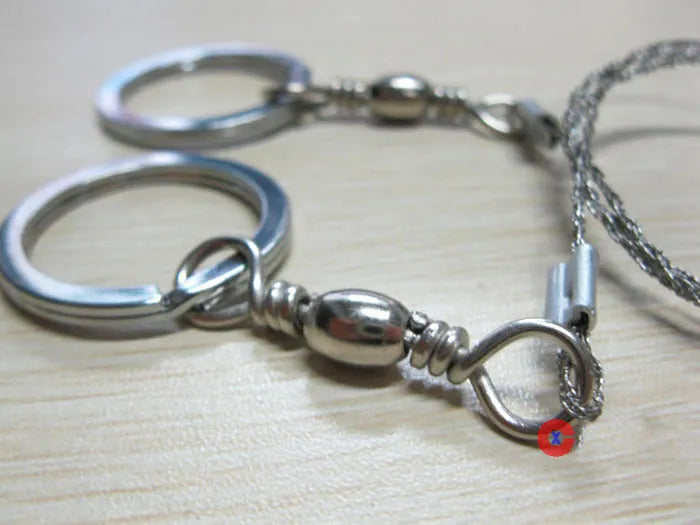 Survival wire saw with stainless steel blade, pull ring, and hoop handles for outdoor cutting