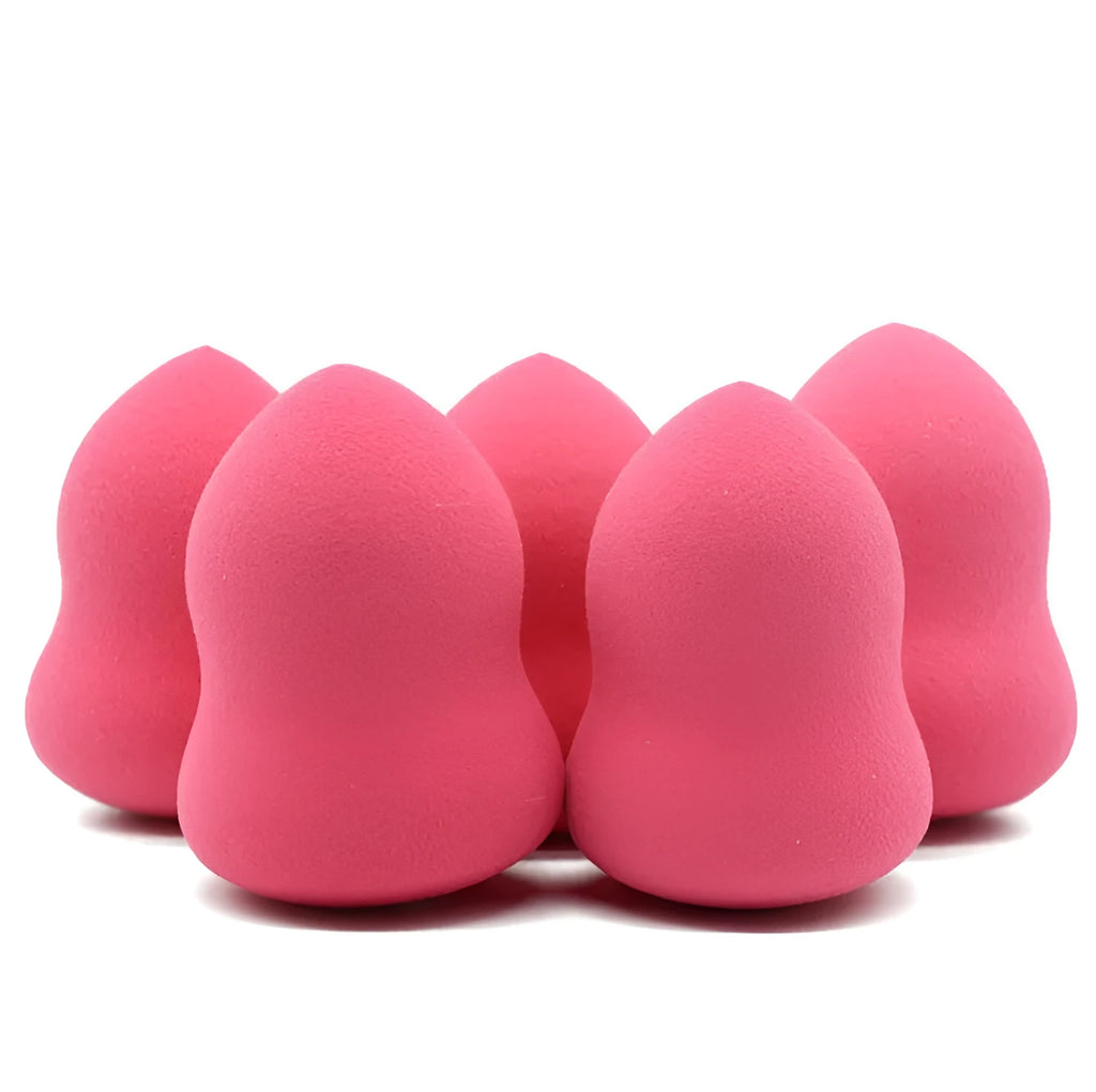 Pink makeup foundation sponge puff on a white background, showing its cubic shape and size.