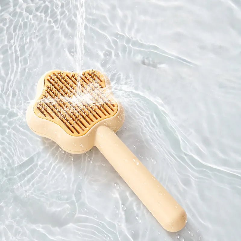 Green self-cleaning stainless steel cat comb with needle teeth on a 20cm handle.