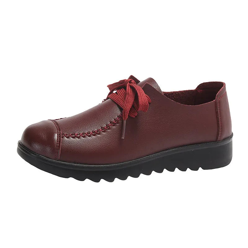 Women's black flat work shoes with round toe, front lacing, and soft anti-slip polyurethane sole