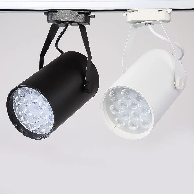 LED track spotlight with aluminium shell in black or white, for clothing store wall lighting.