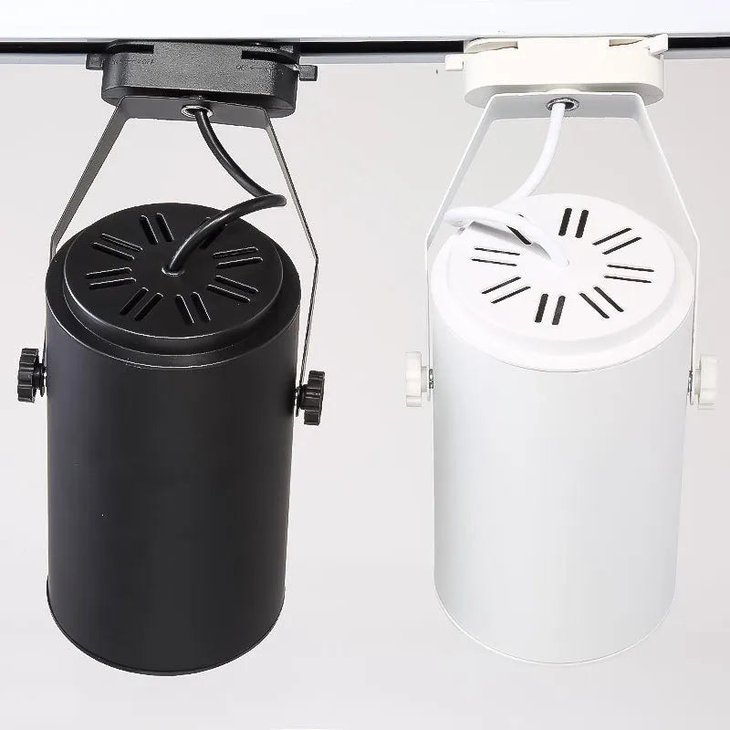 LED track spotlight with aluminium shell in black or white, for clothing store wall lighting.
