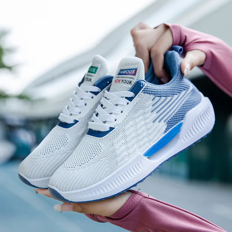 A pair of blue men's casual mesh sports shoes with a round toe and cloth upper.
