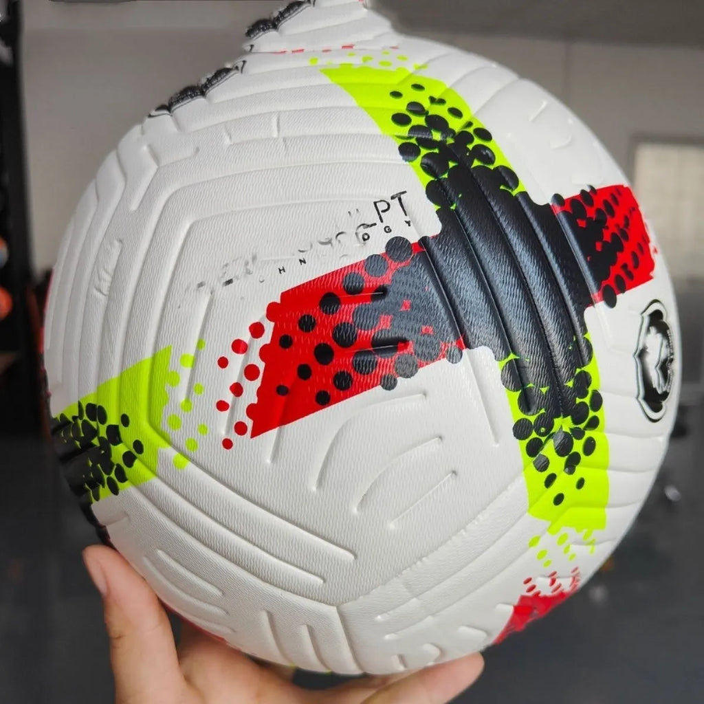 Fluorescent green official size 5 football with seamless thermal patch construction on a pitch.