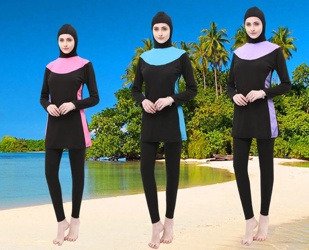 Women's black and blue hooded long sleeve swimsuit top and pants on a hanger.