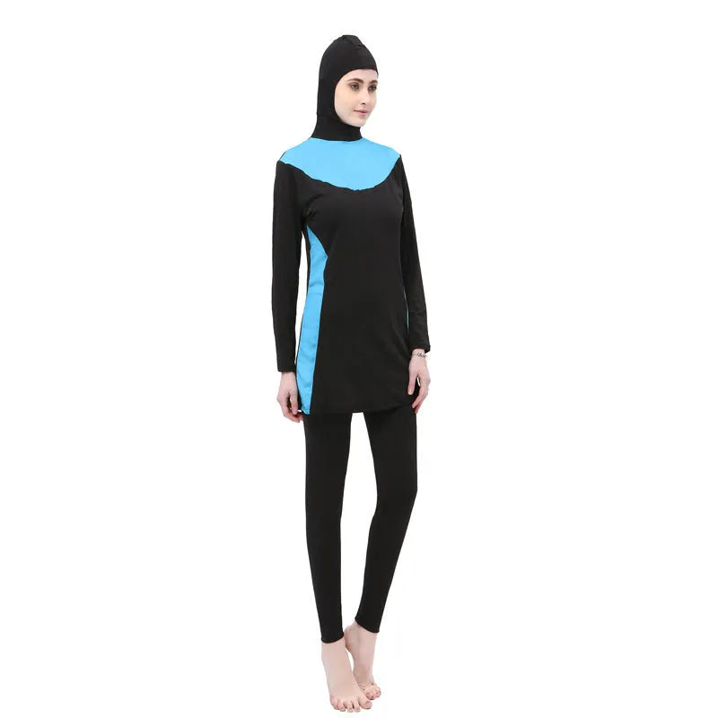 Women's black and blue hooded long sleeve swimsuit top and pants on a hanger.