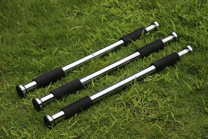 Steel adjustable pull-up bar extended between door frames for home fitness training