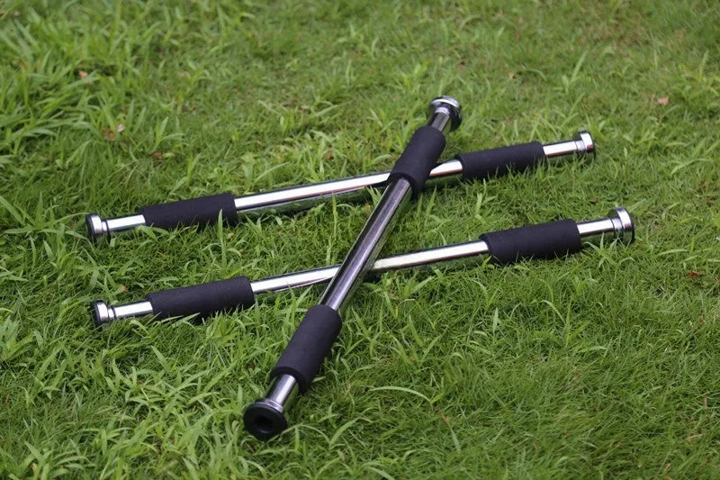 Steel adjustable pull-up bar extended between door frames for home fitness training