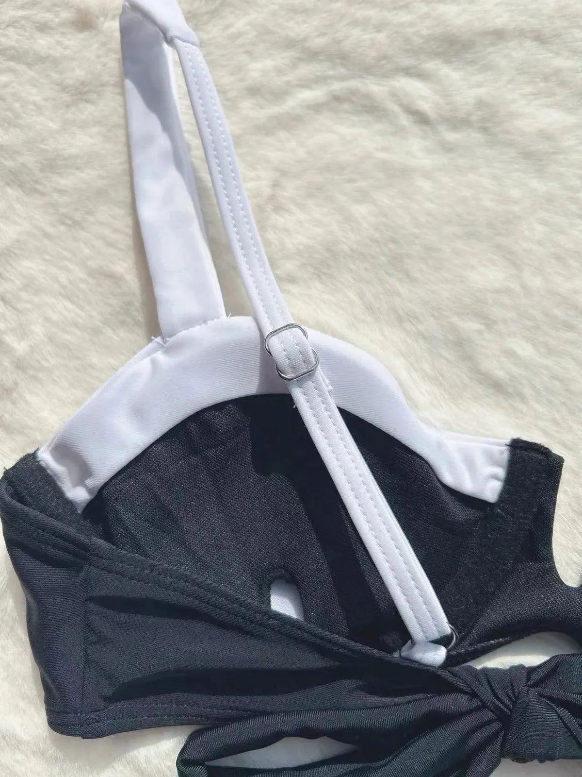 Black low waist bikini swimsuit with stitching split design on mannequin showing front and back views
