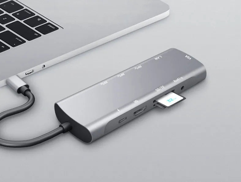 Grey aluminium USB-C docking station with HDMI, VGA, and USB ports on 140mm cable