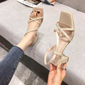 Women's white thick heel gladiator sandals with an 8cm high platform wedge.