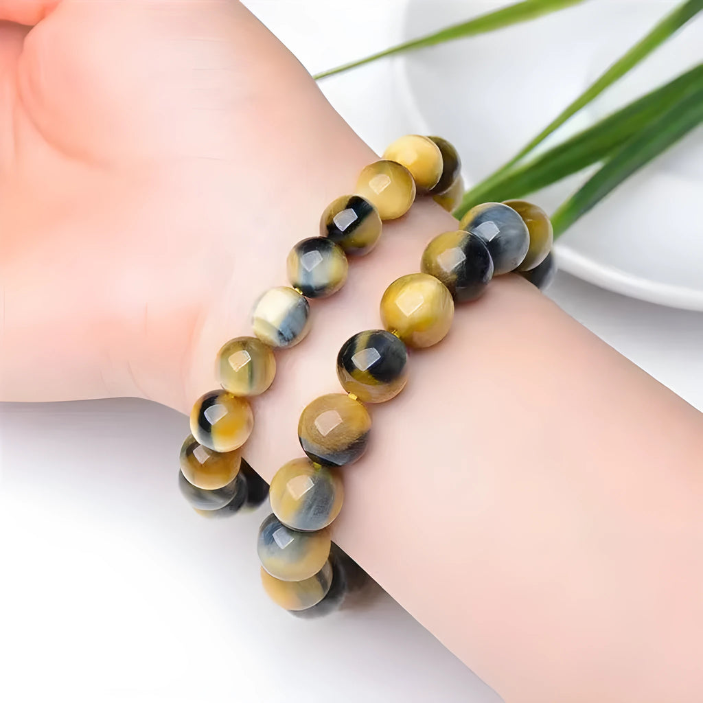 Fantasy Tiger Eye agate bracelet with round beads in a single circle design on a wrist.