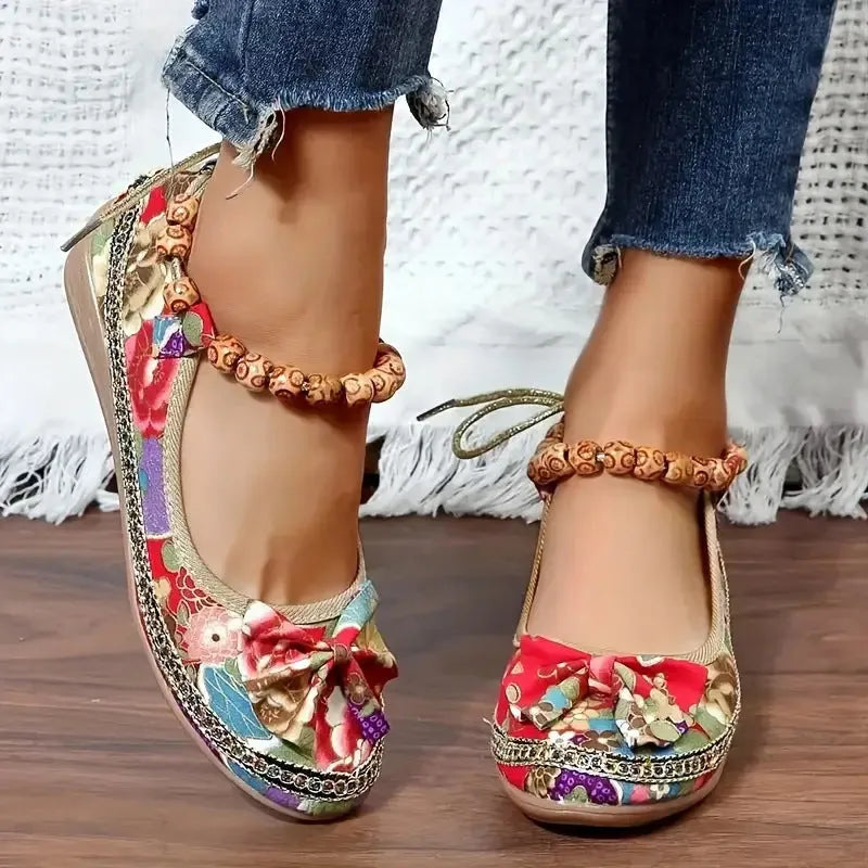 Women's black plus size ethnic platform sandals with elastic band fastening.