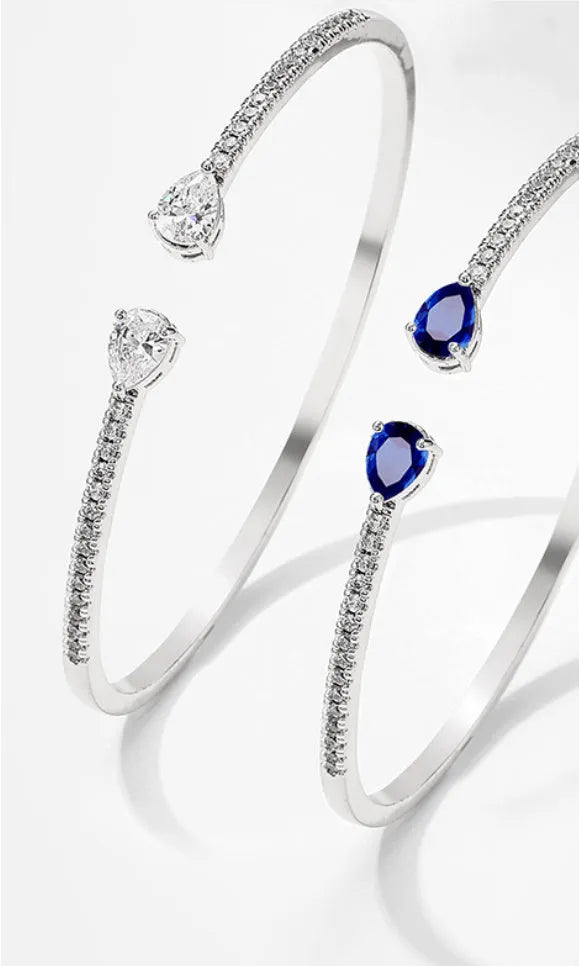 Copper fashion bracelet with multi-zircon inlay decoration, shown in white and blue colour options.
