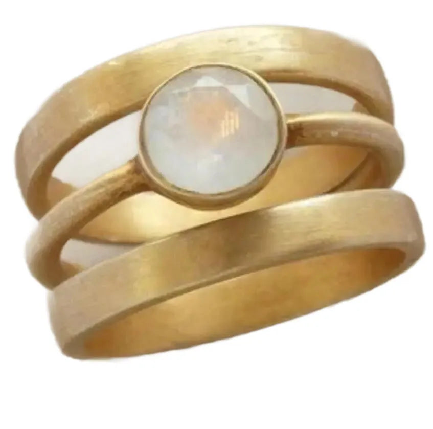 Gold geometric hollow ring with white chalcedony stone on a titanium steel band.