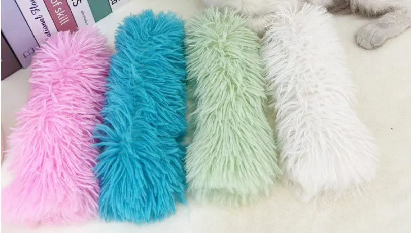 Soft plush cat toy pillow in blue, green, pink, and white colours, shown next to a measuring tape indicating 27cm length.