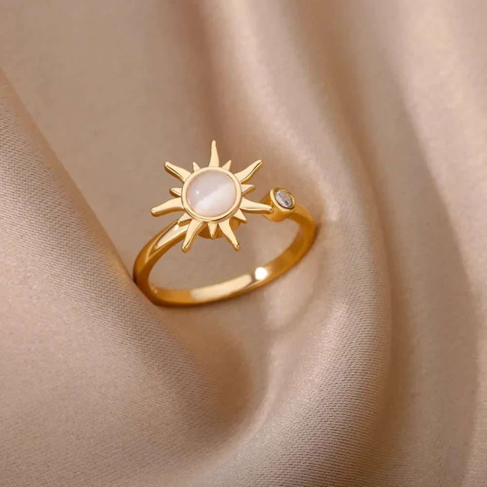 Gold and platinum adjustable open-mouth decompression ring with rotatable geometric component.