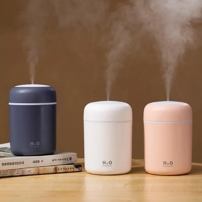 USB-powered mini humidifier with colourful LED lights in pink, white, or navy blue colour options