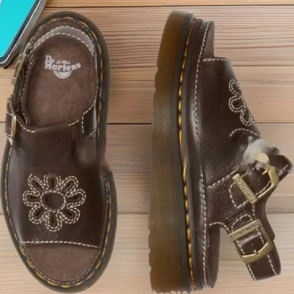 Men's black embroidered floral beach sandals with a flat heel on a plain background.