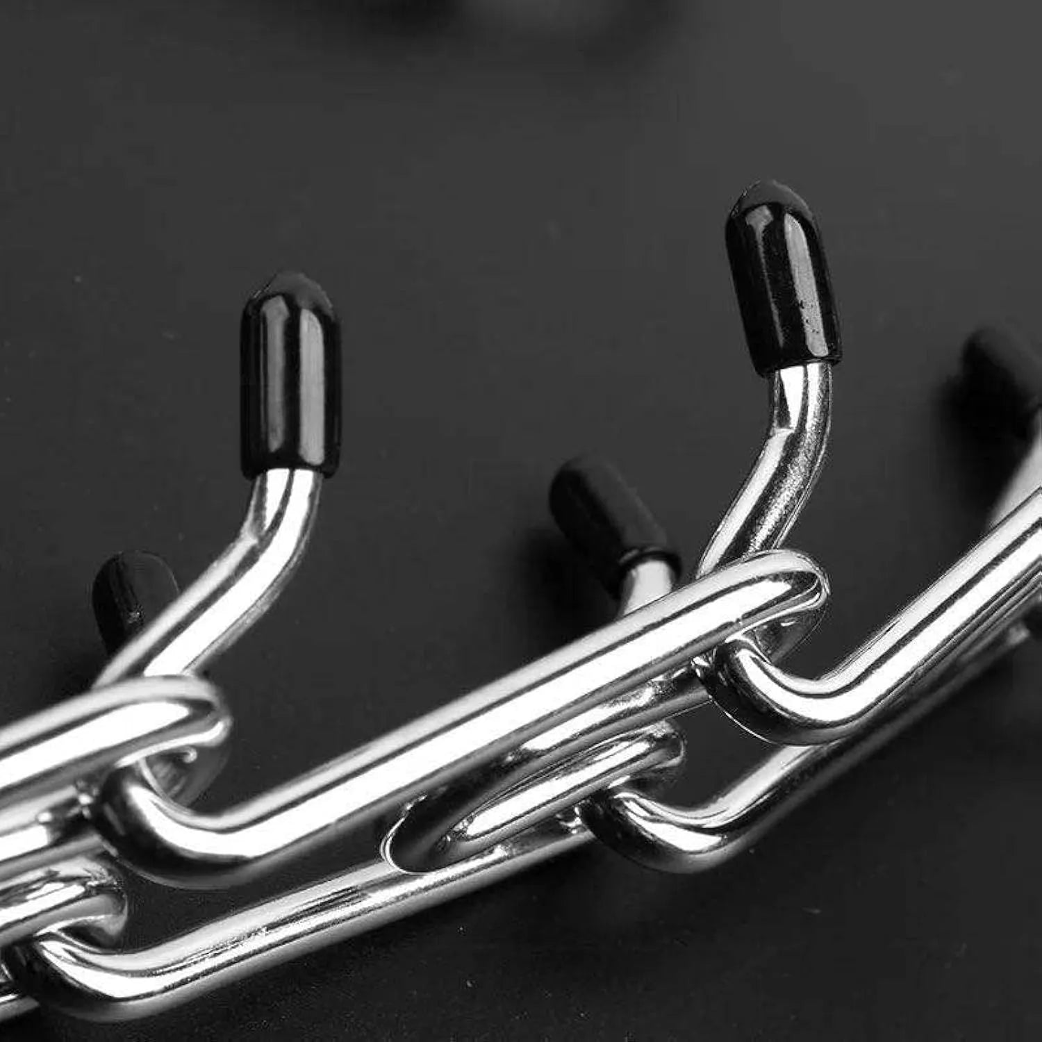 Stainless steel dog prong training collar with rubber tips, shown with adjustable links in four sizes.