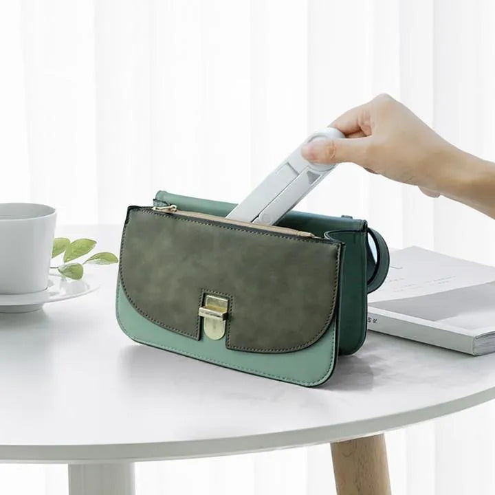 Black foldable tablet holder showing adjustable angle stand with phone positioned in landscape orientation