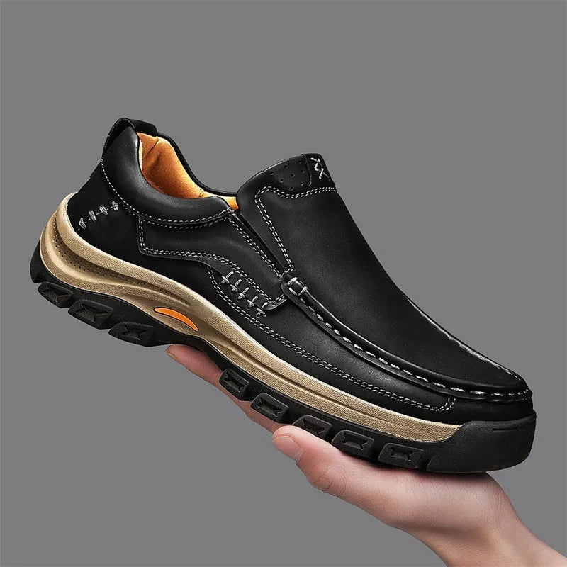 Men's black leather mountaineering shoes with thick rubber soles and round toe.