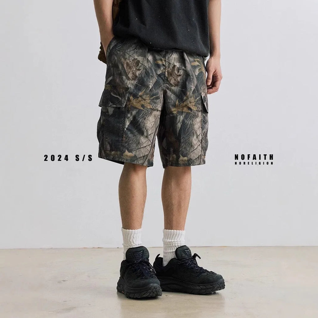 Loose fit straight-leg denim shorts on hanger, showing micro-elastic waistband and zip fly in army green colour.