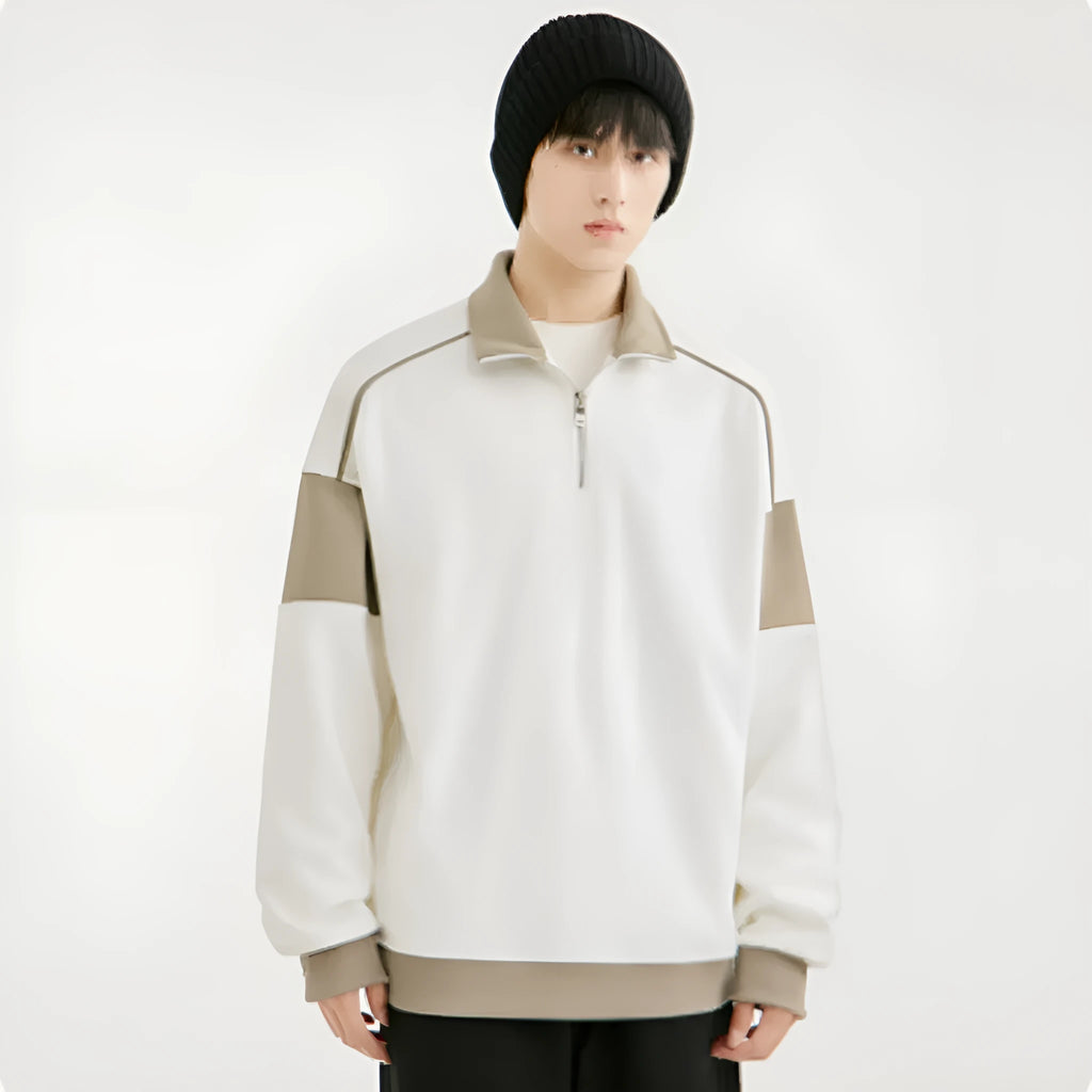 Man modelling a hooded black corduroy sweatshirt with drop shoulders and loose lapels.