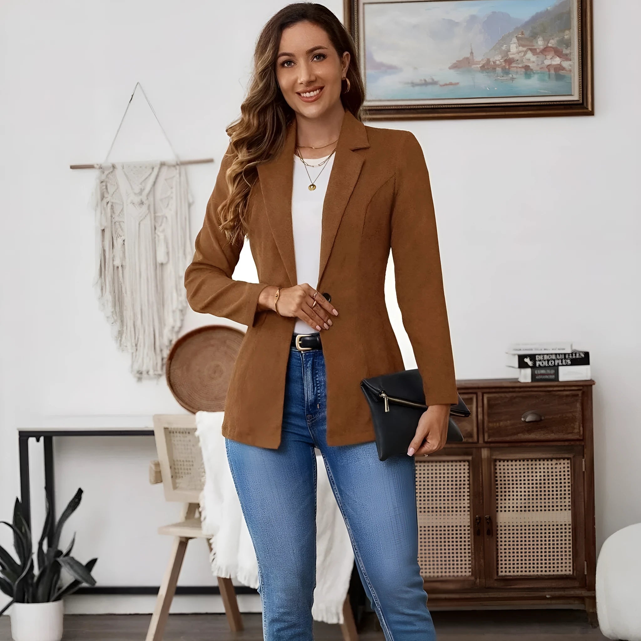 Brown single-breasted leisure blazer with lapel collar and long sleeves on a hanger.