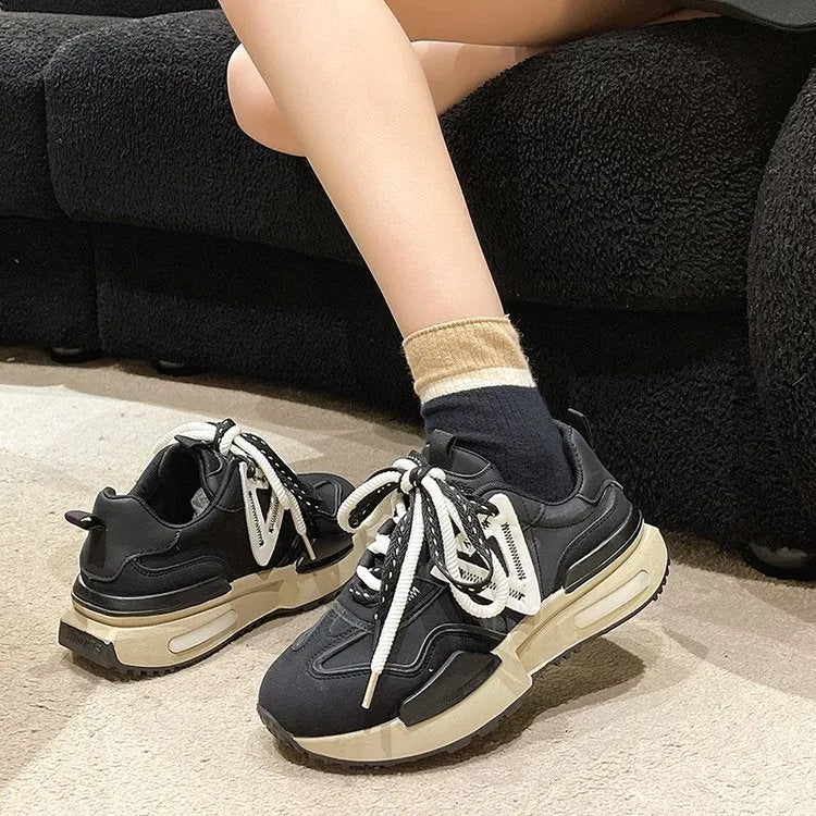 Women's black retro platform sports shoes with chunky rubber soles and lace-up closure