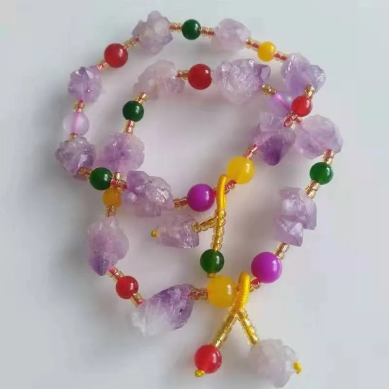 Natural purple amethyst bead bracelet for women with a fu character charm on a white background.