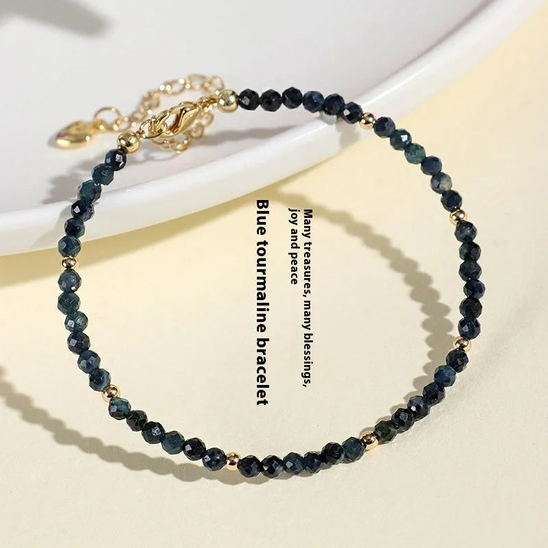 Blue tourmaline 3mm bead bracelet with spacer design on wrist
