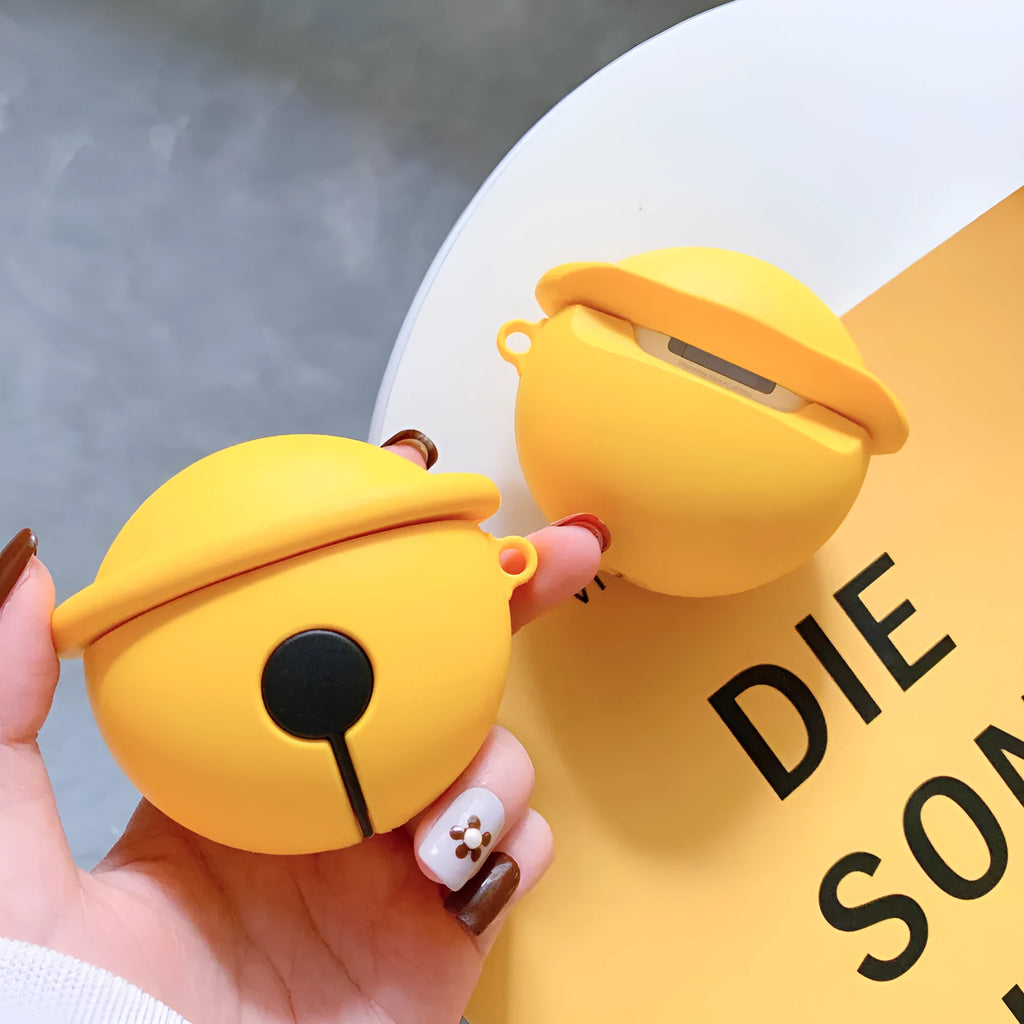 Yellow silicone AirPods case with a small silver bell charm attached