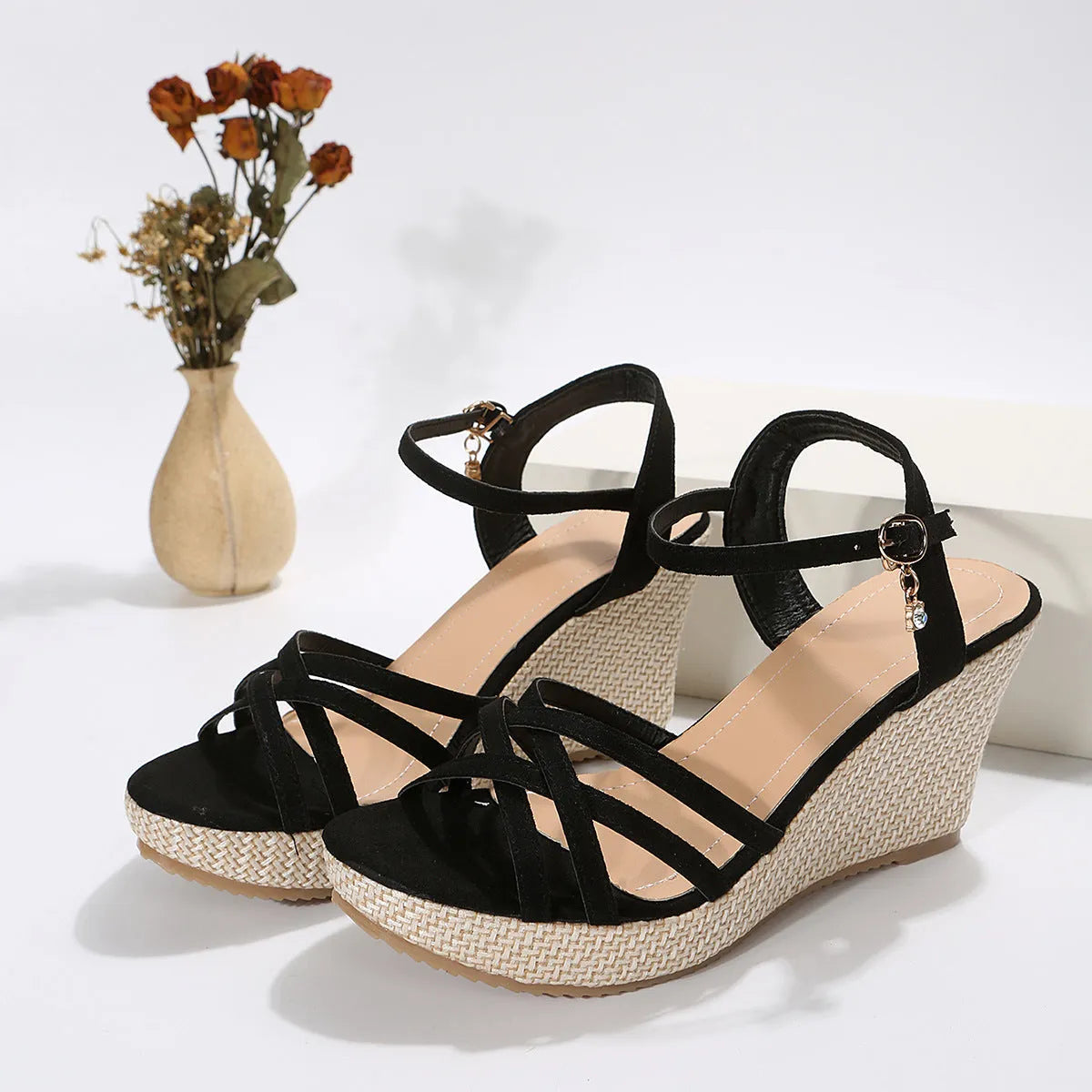 Beige and black women's wedge sandals with a cloth upper and fish mouth toe opening.
