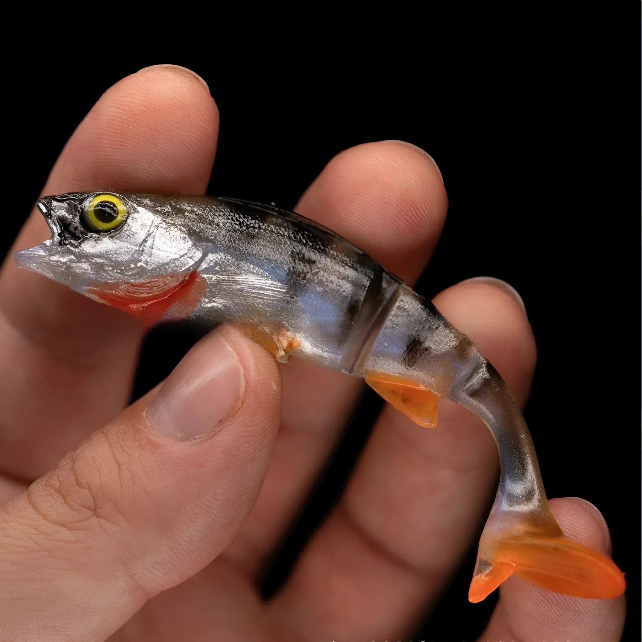 Fish-shaped soft fishing lure with T-tail design and realistic scales in natural fish colours