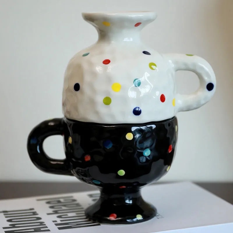 Hand-pinched irregular shaped ceramic mug in a solid colour on a table
