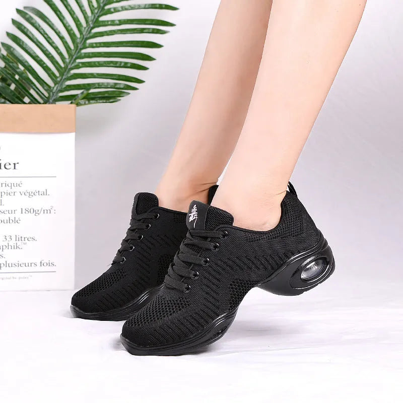 Women's white breathable mesh dance shoe with a lightweight PU sole on a studio floor.