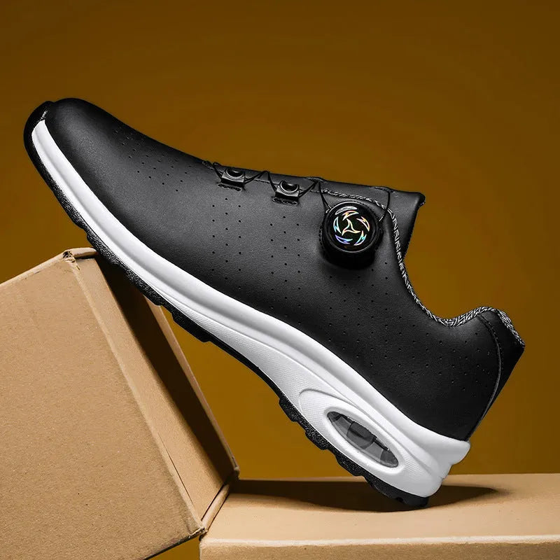 Black and white low top casual shoes with mesh upper, composite sole, and cross shoulder straps
