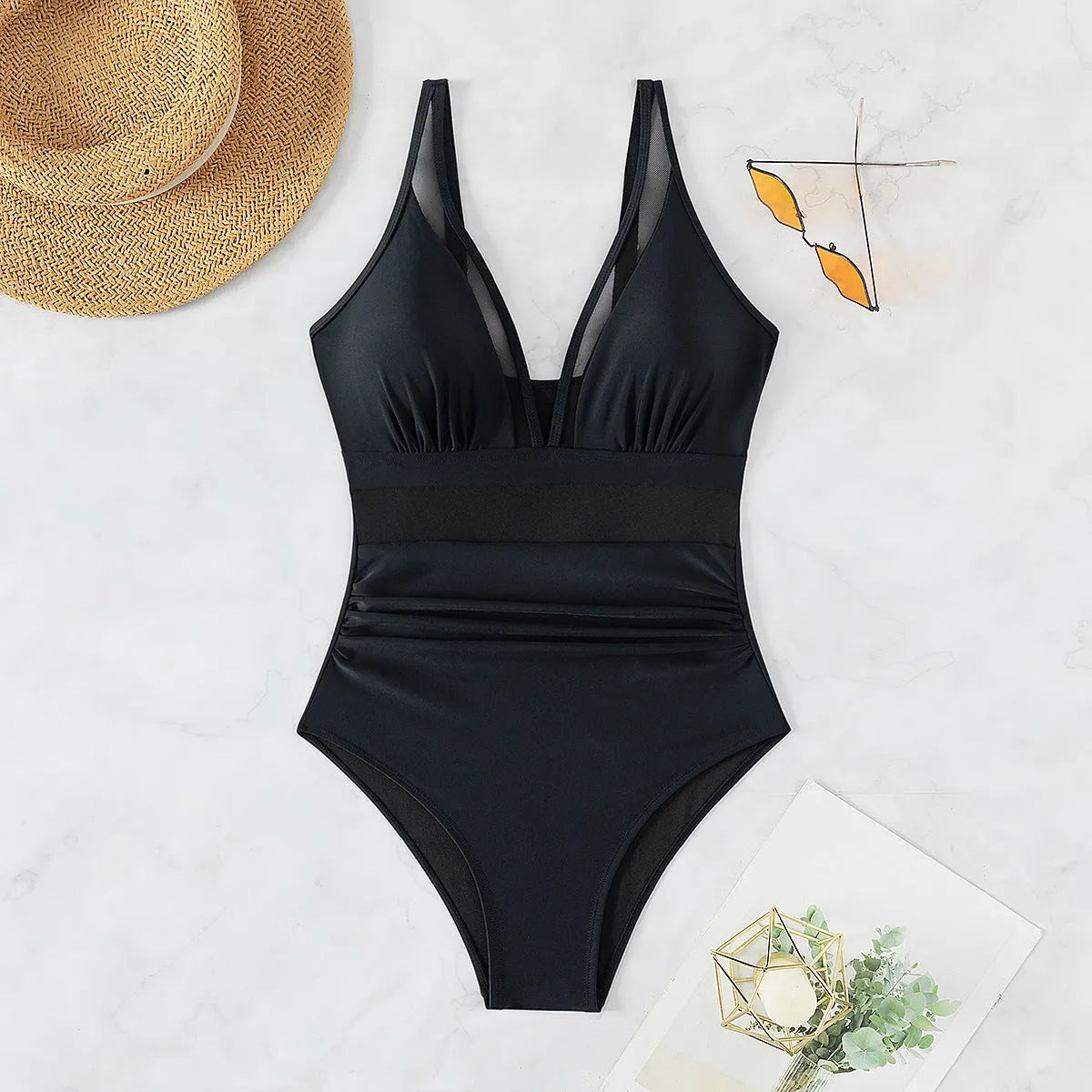 Black women's halter neck one-piece swimsuit with mesh panels on mannequin
