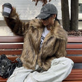 Short black artificial fur coat with a large fur collar, shown on a model.