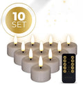 Four taupe-coloured LED tealight candles with 3D flame effect on wooden surface