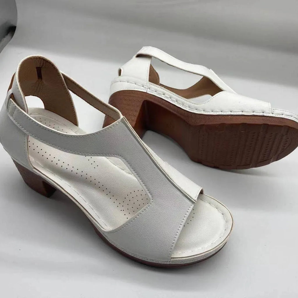 Women's beige peep toe wedge sandals with a buckle ankle strap and low rubber sole.
