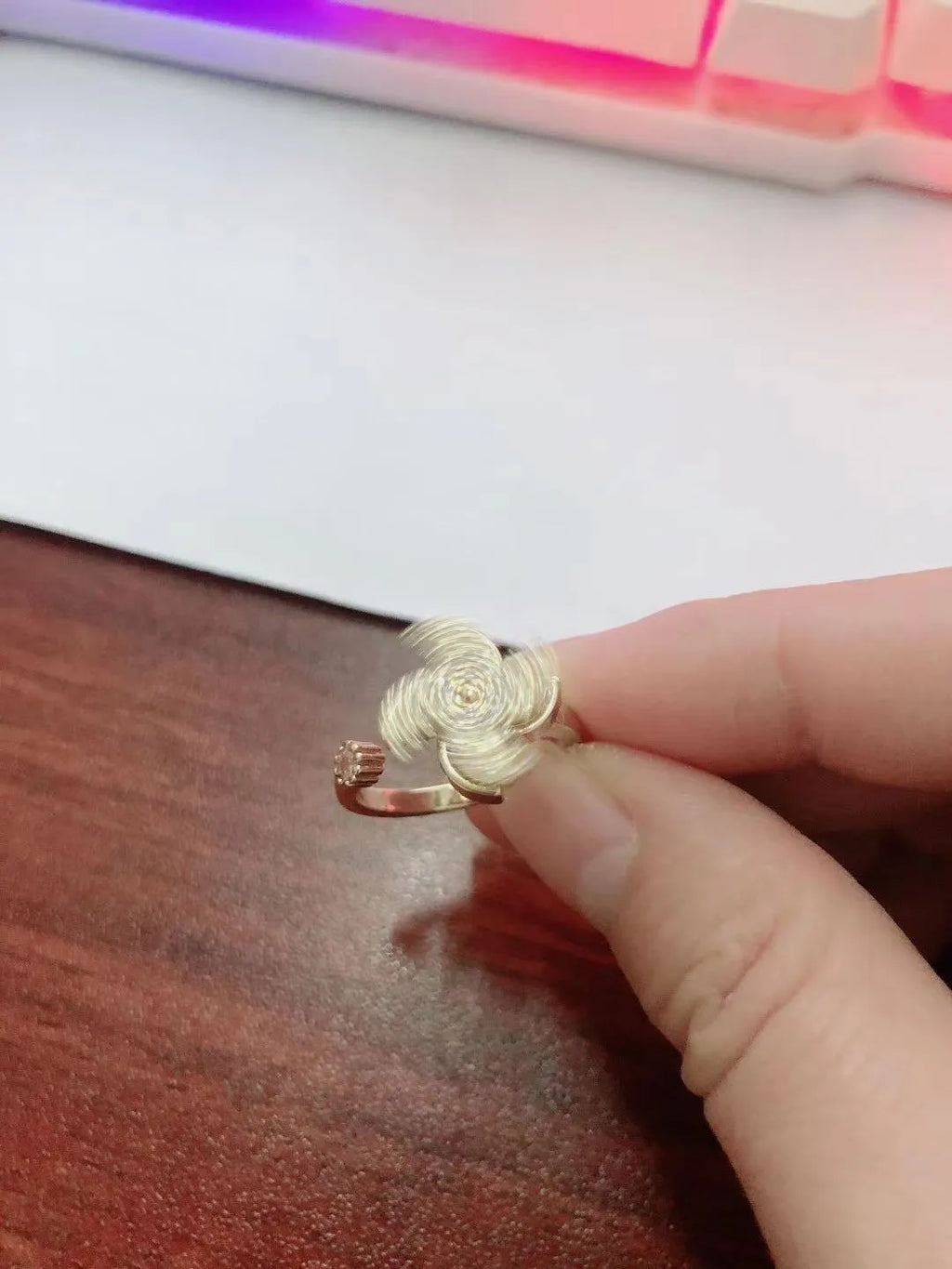 Rotating geometric ring with spinning windmill design in gold or silver electroplated finish