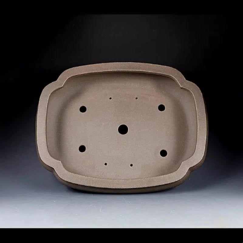 Handmade antique papaya-shaped purple clay flower pot, 46cm long, on a wooden surface.
