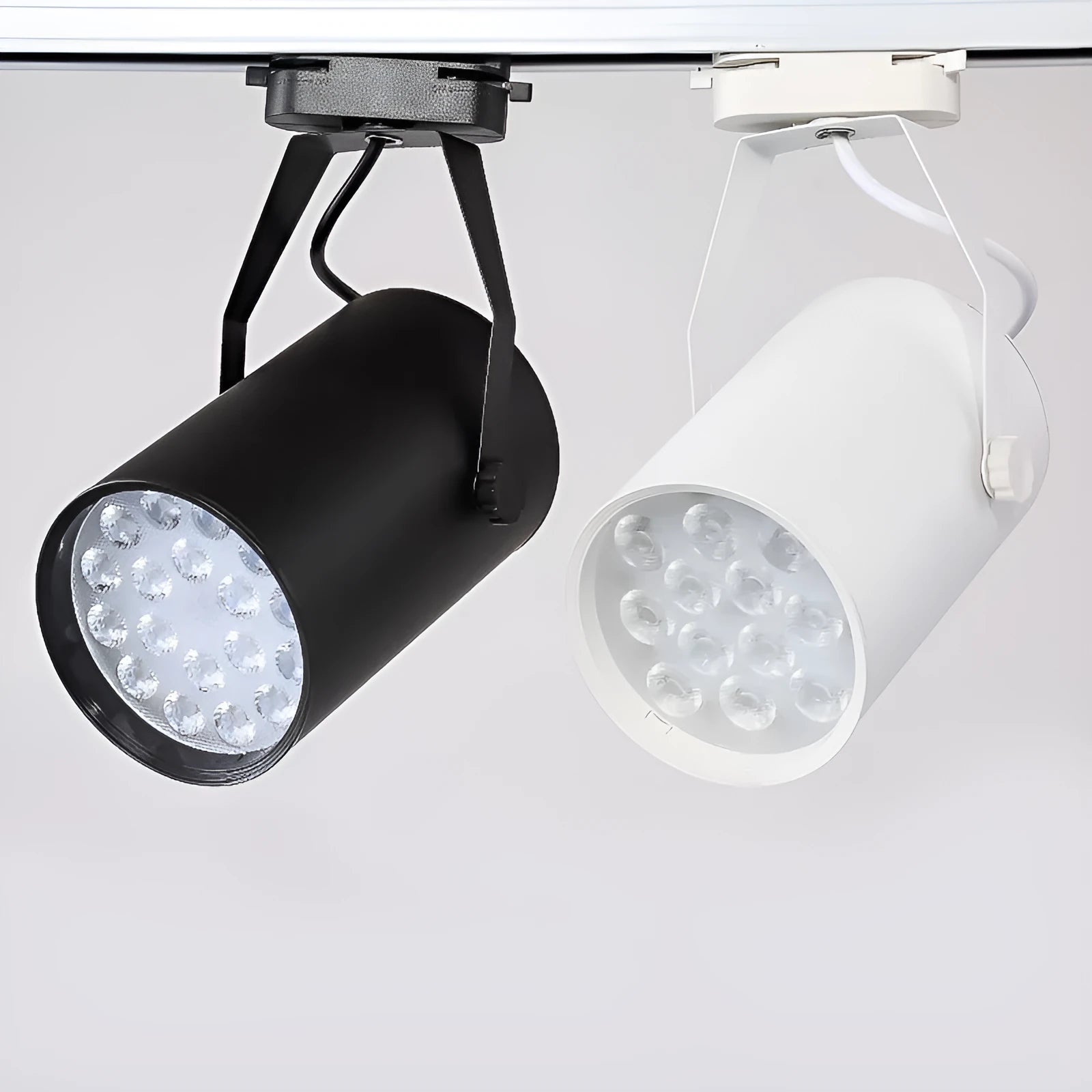 LED track spotlight with aluminium shell in black or white, for clothing store wall lighting.