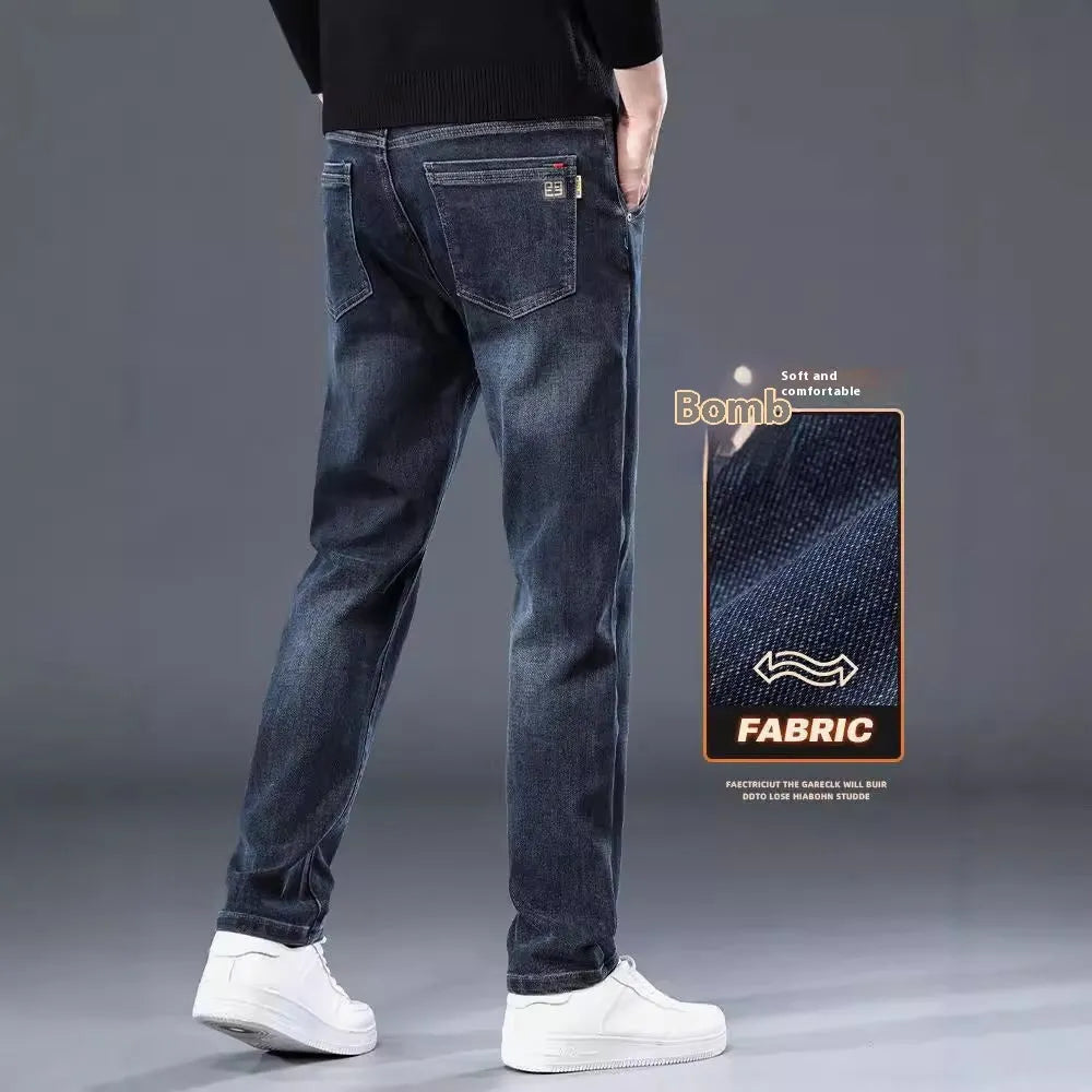 Men's slim straight casual trousers in blue-grey, showing a loose fit and zip fly detail.