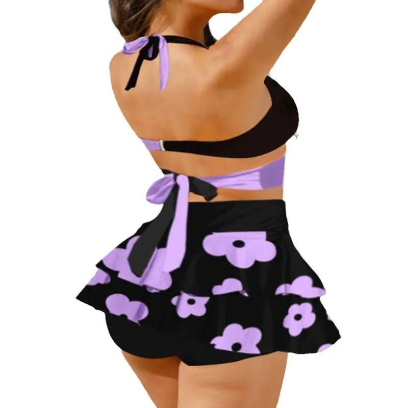 Purple women's high-waisted bikini set with matching skirt and lace-up detail