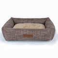 Square grey plaid cloth dog bed for medium-sized dogs on a wooden floor.